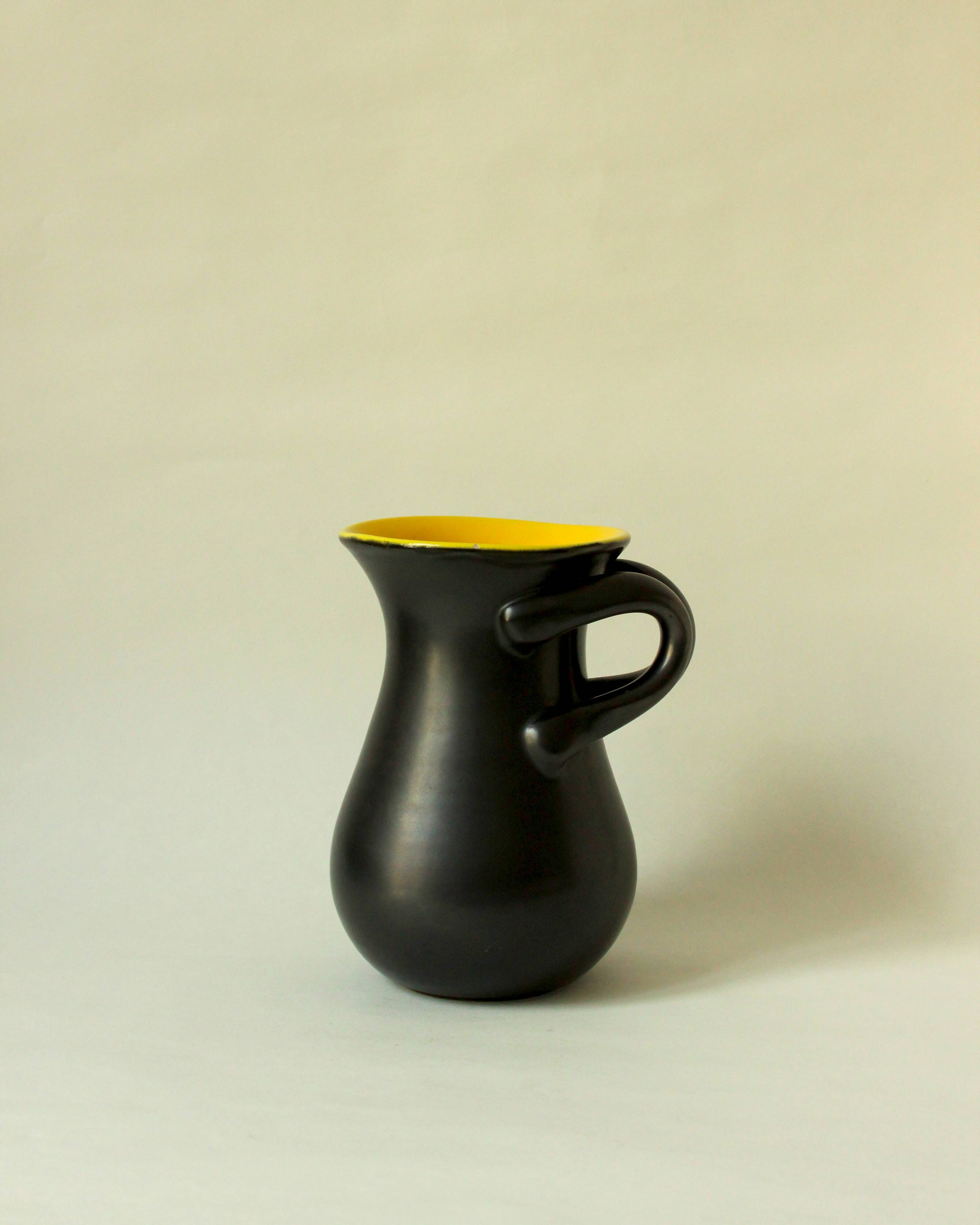 Glazed ceramic vase in black and yellow, in the style of Pol Chambost.