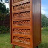 Tall chest of drawers in wood and rattan with splayed legs