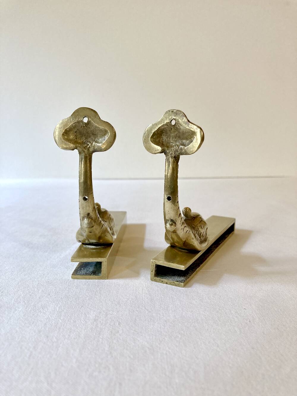 Brass wall supports for bathroom shelf, circa 1950.