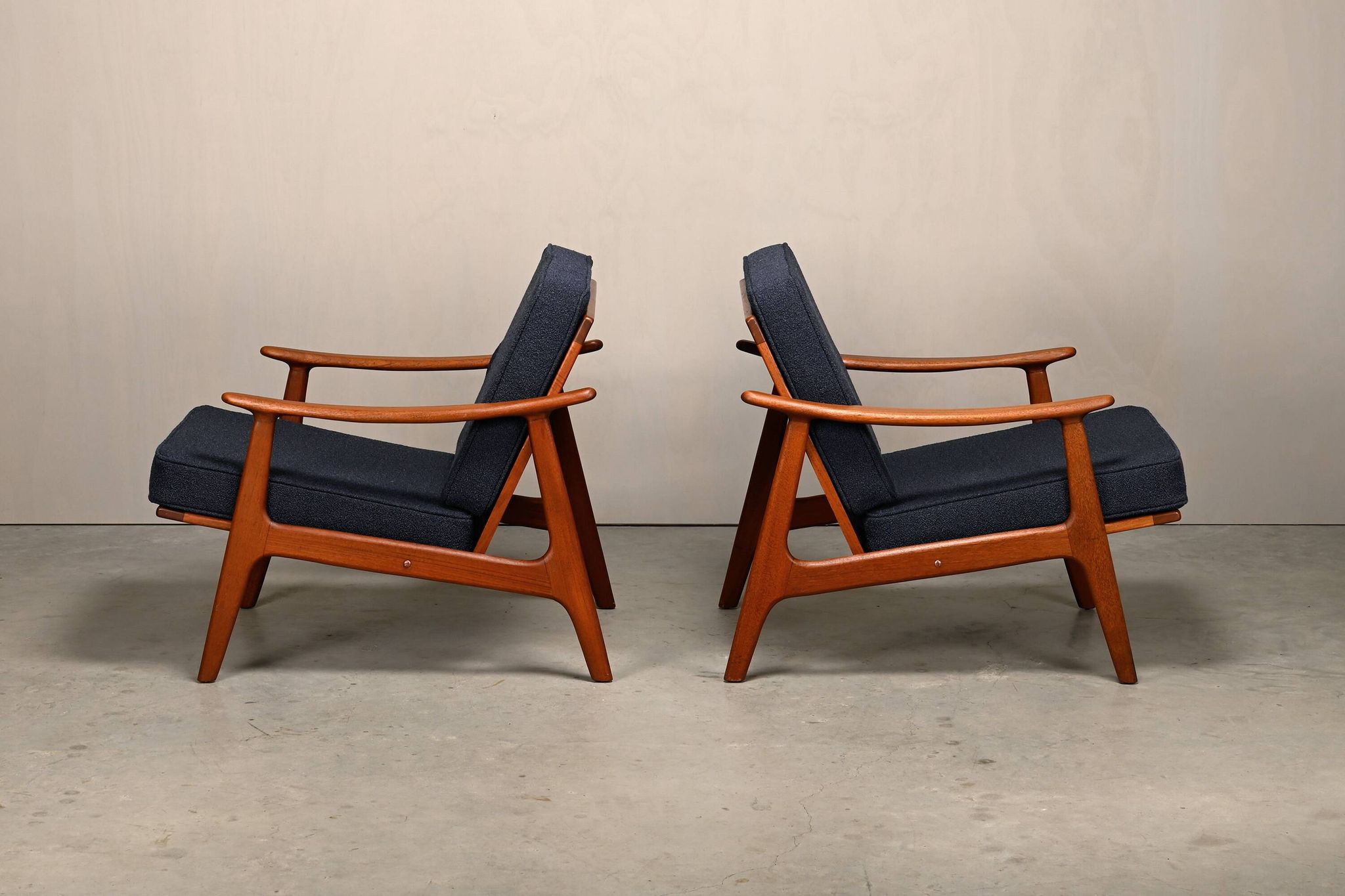 Pair Scandinavian Modern armchairs in teak and dark blue bouclé fabric