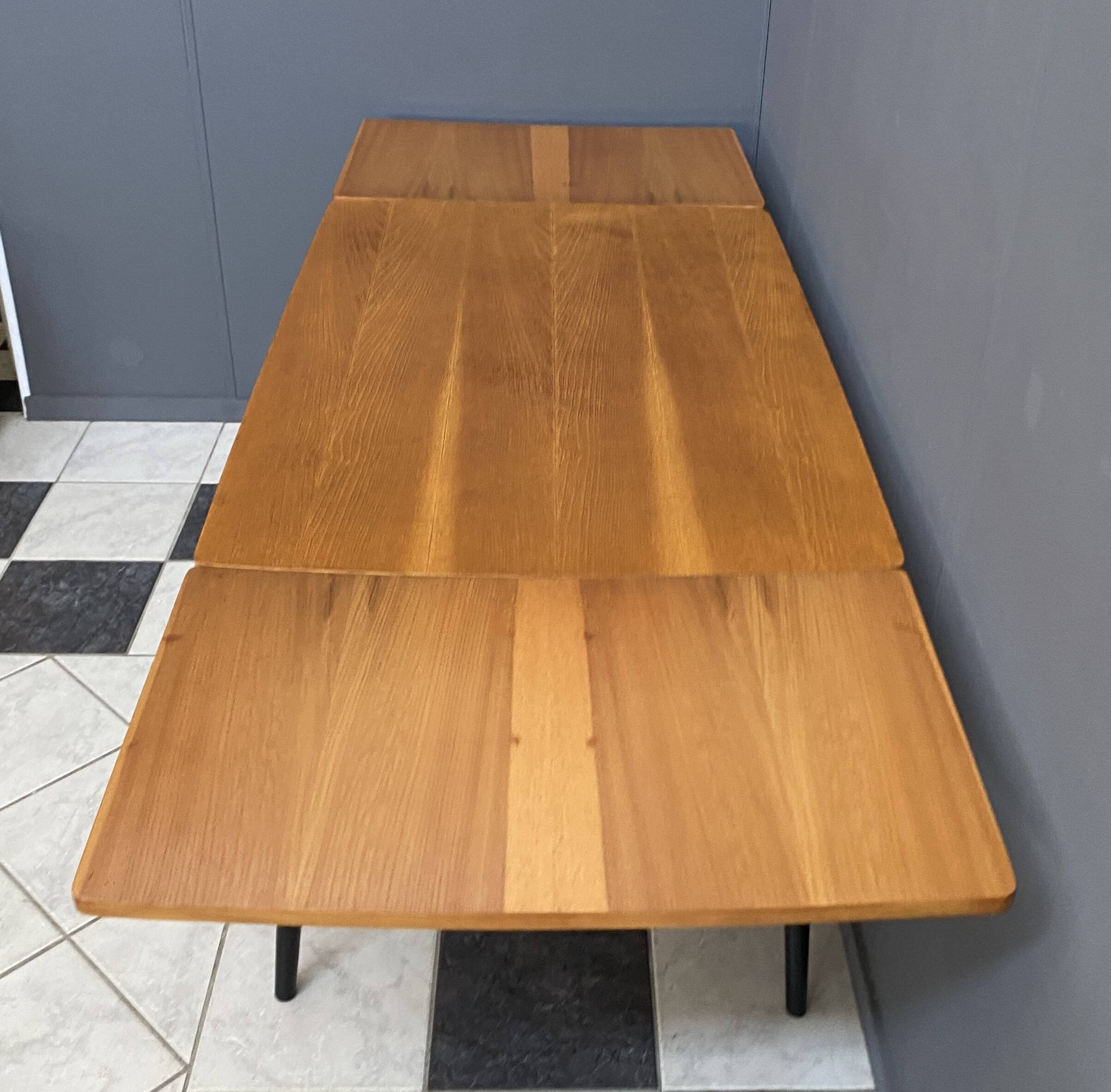 Wood enlarging dining table black wood legs 1960s