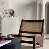 Reclined armchair in canned teak in natural wood