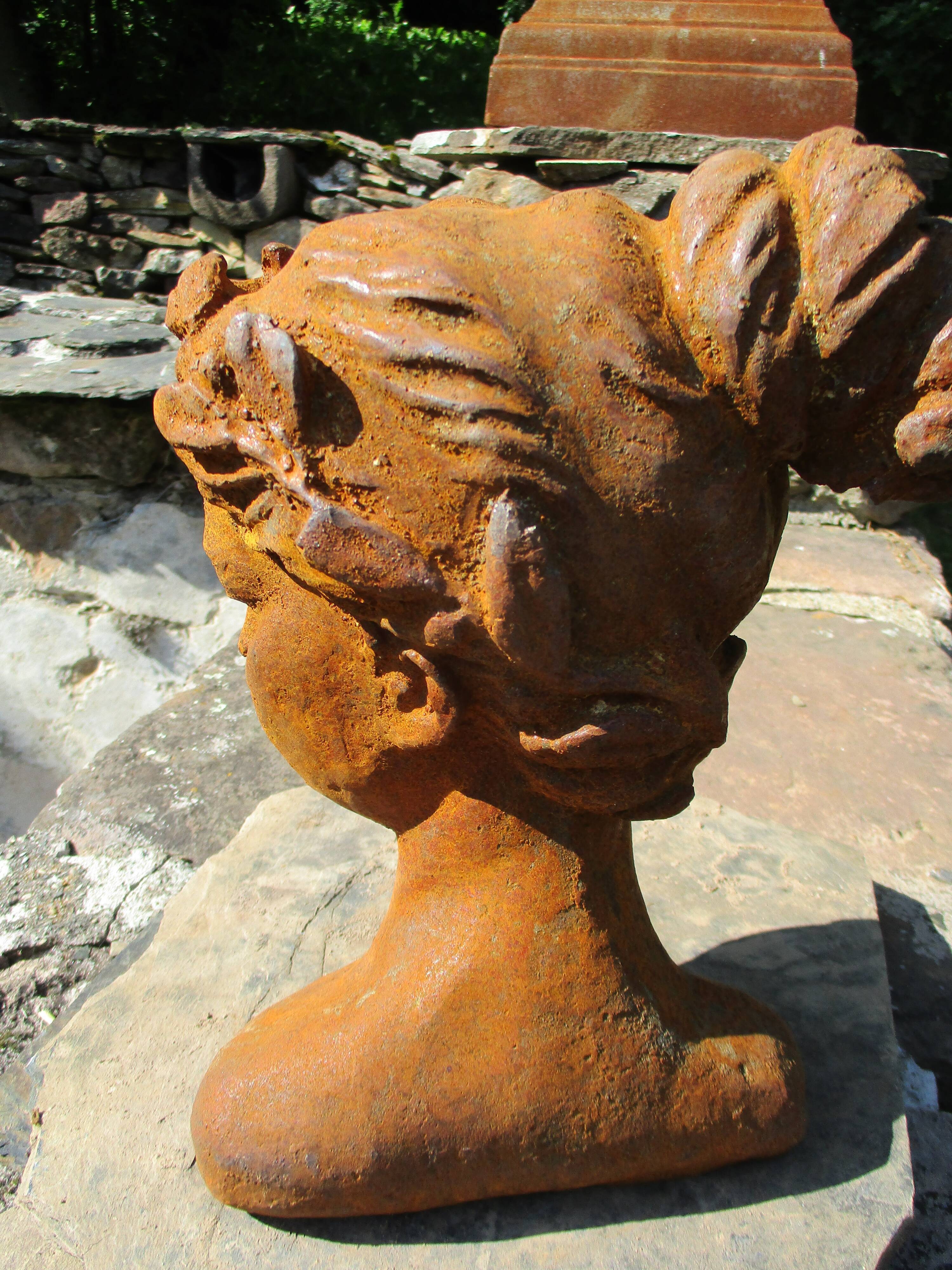 Cast iron sculpture of a woman.