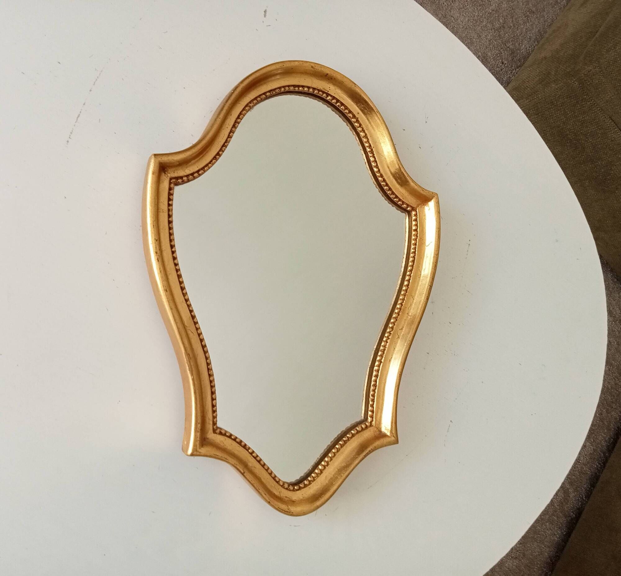 Vintage baroque mirror in gilded wood in the Louis XV style.