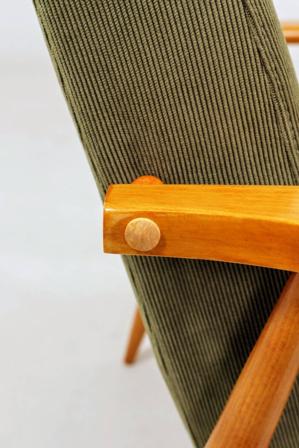 Mid-century modern design armchair in olive green corduroy.