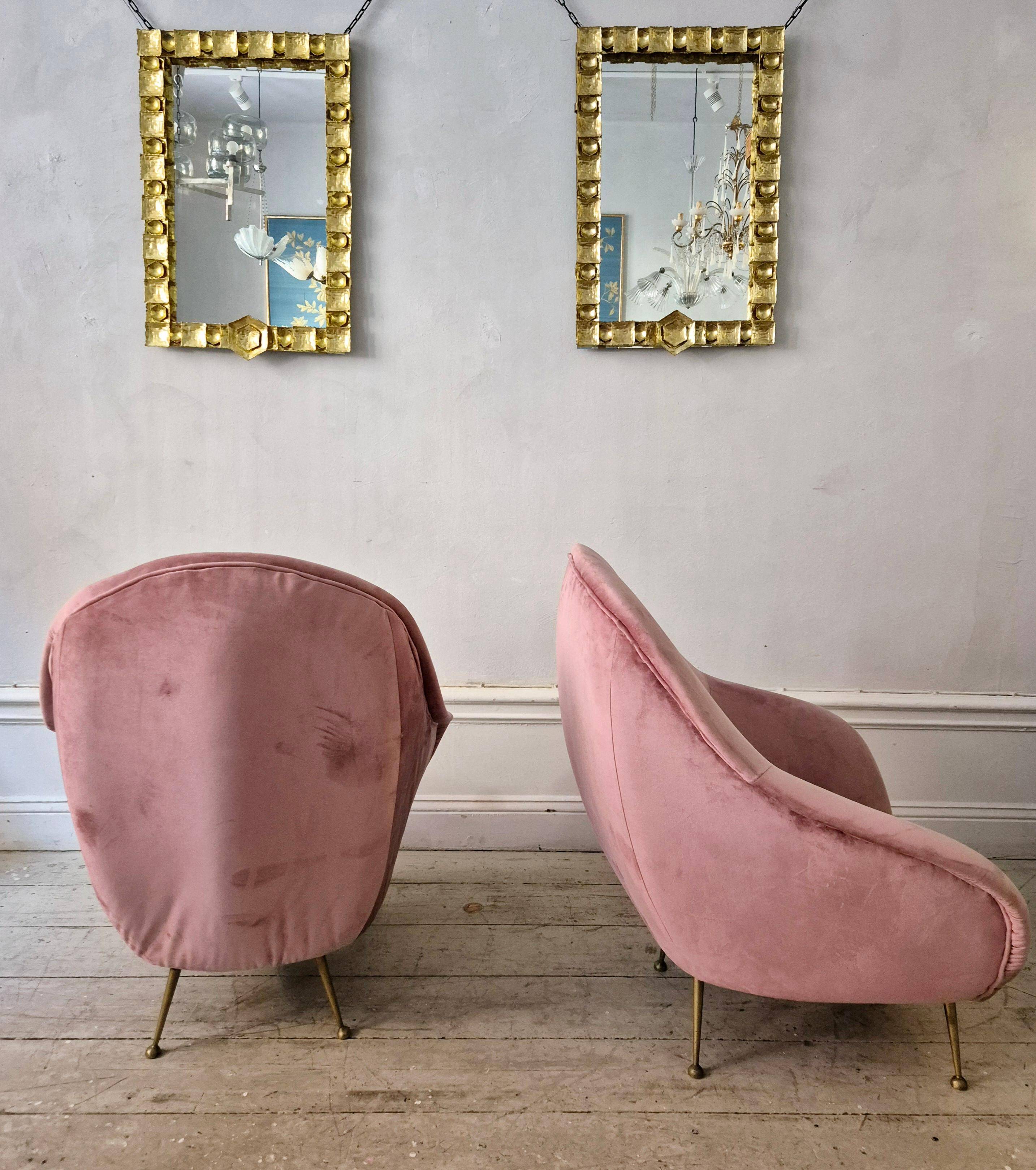 An elegant pair of armchairs with brass legs, Italy from the mid-20th century.