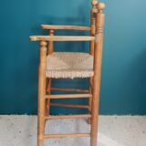 Children's high chair made of wood and straw