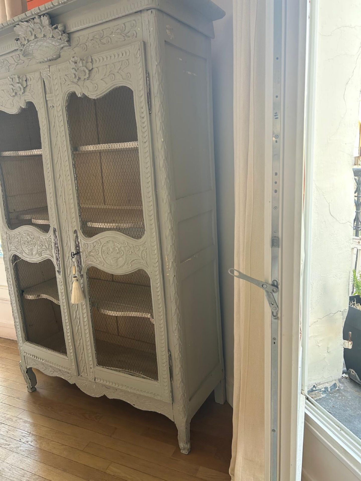 Antique French carved display cabinet with wire mesh doors