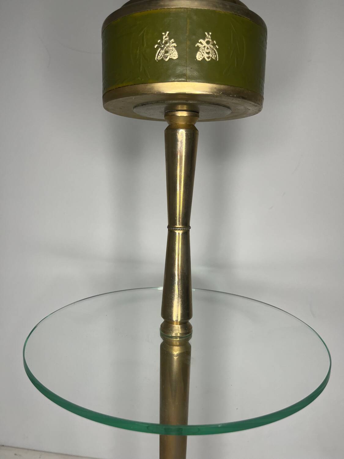 Vintage brass floor ashtray with glass shelf in Empire style.