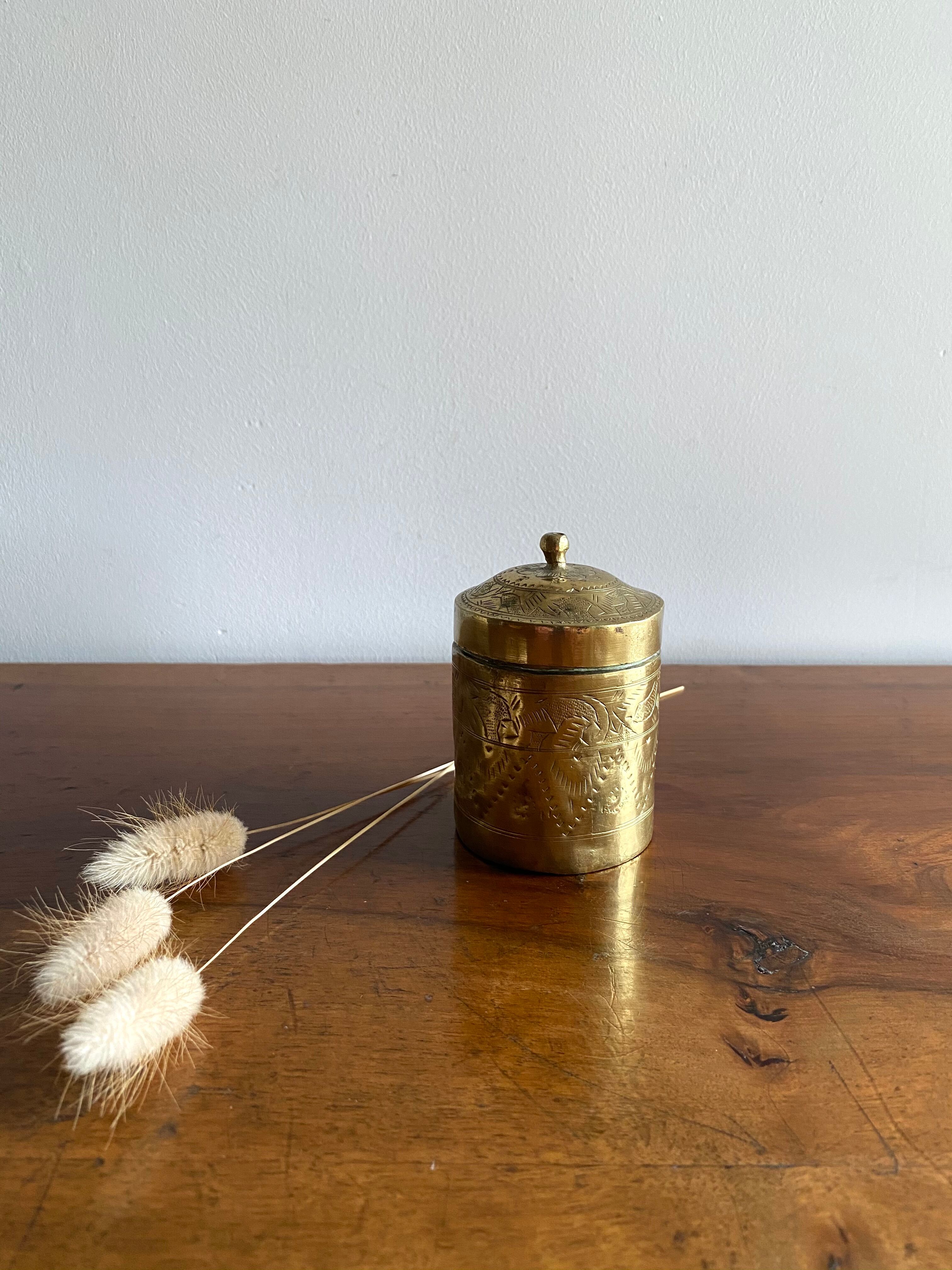 Old round box in chiseled brass