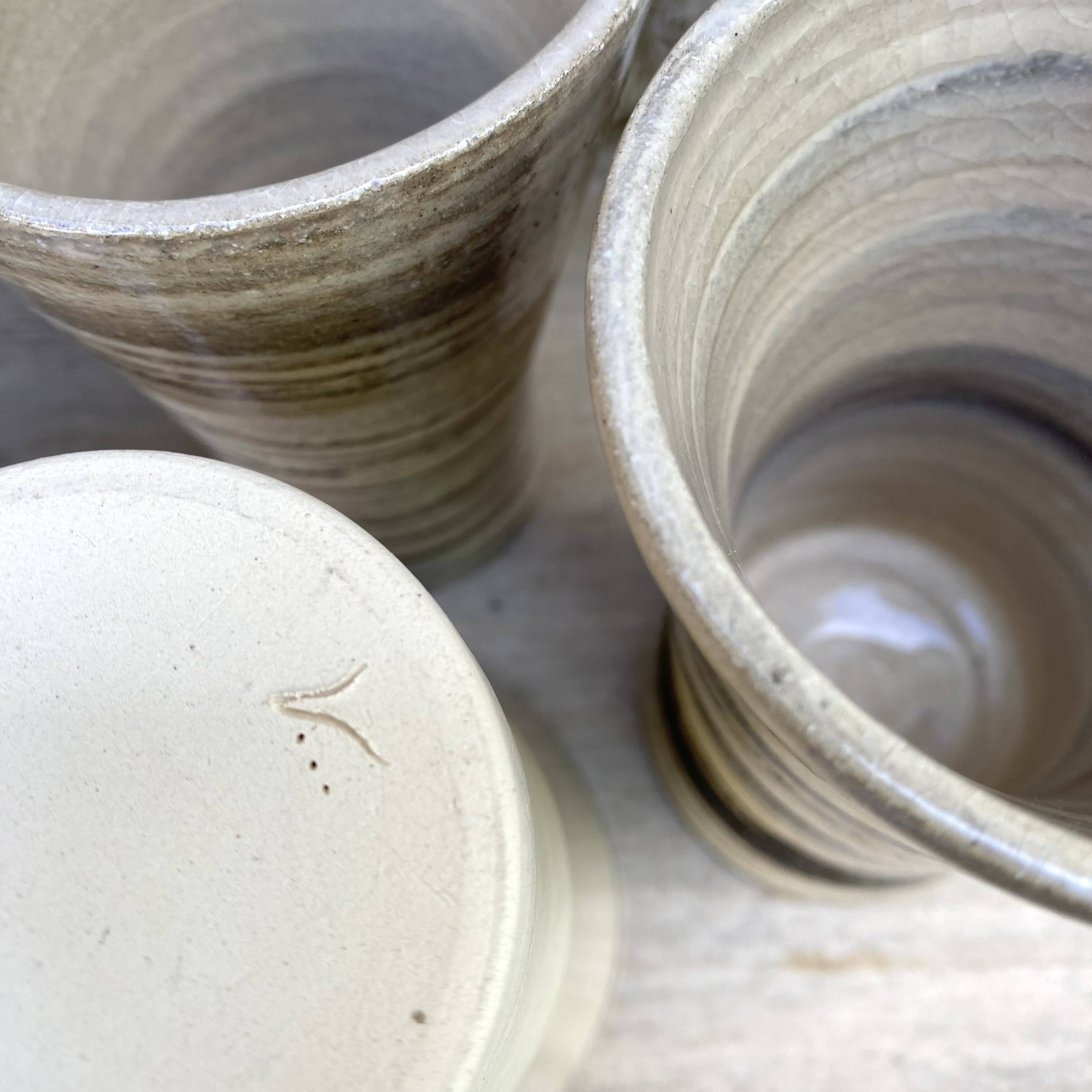 High ceramic cups made of mixed clay.