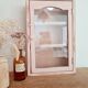 Medicine cabinet in patinated pink wood