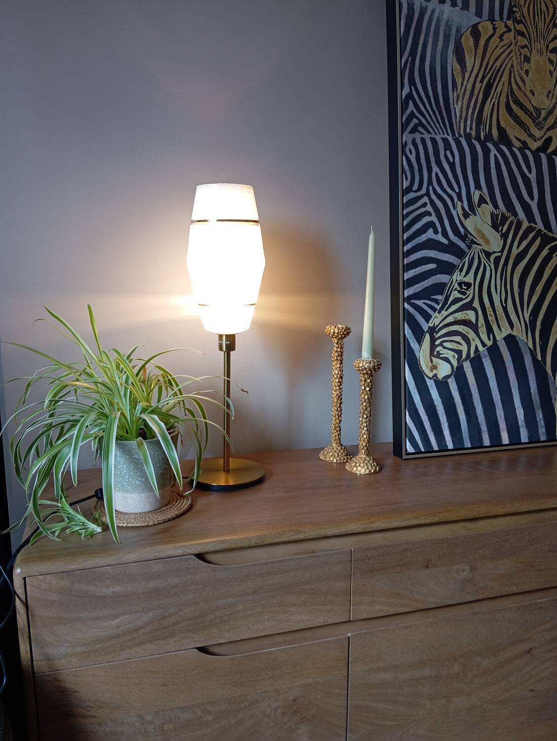 Mid-century gold metal table lamp with white striped shade