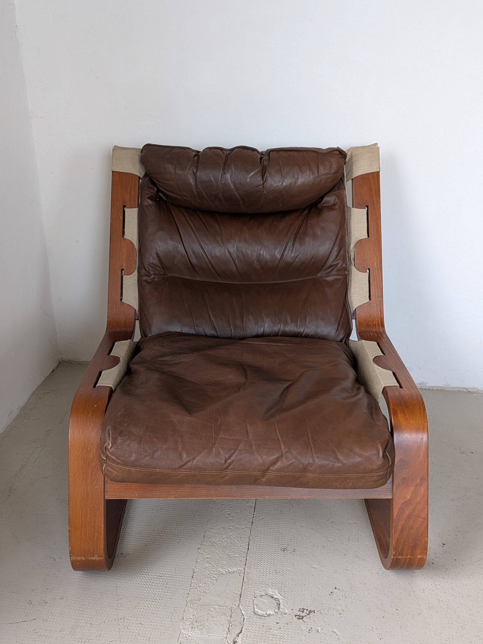 Leather and wood armchair, brutalist style.