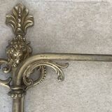 Adjustable wall light in brass and gold metal.