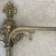 Adjustable wall light in brass and gold metal.