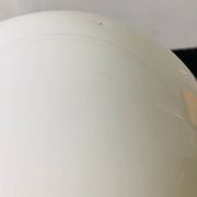 Black wrought iron lamp with a white glass globe.