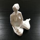 Statuette woman seated in plaster