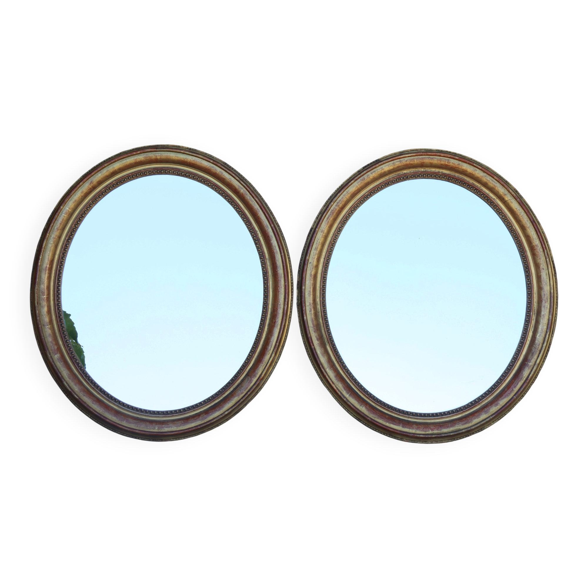 Pair of oval mirrors from the Louis Philippe period in gilded wood.