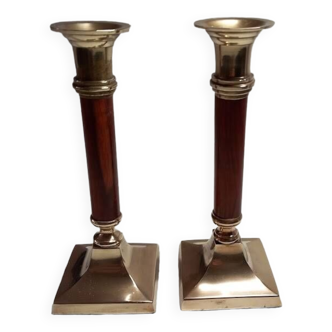 Old candlesticks in brass and red wood