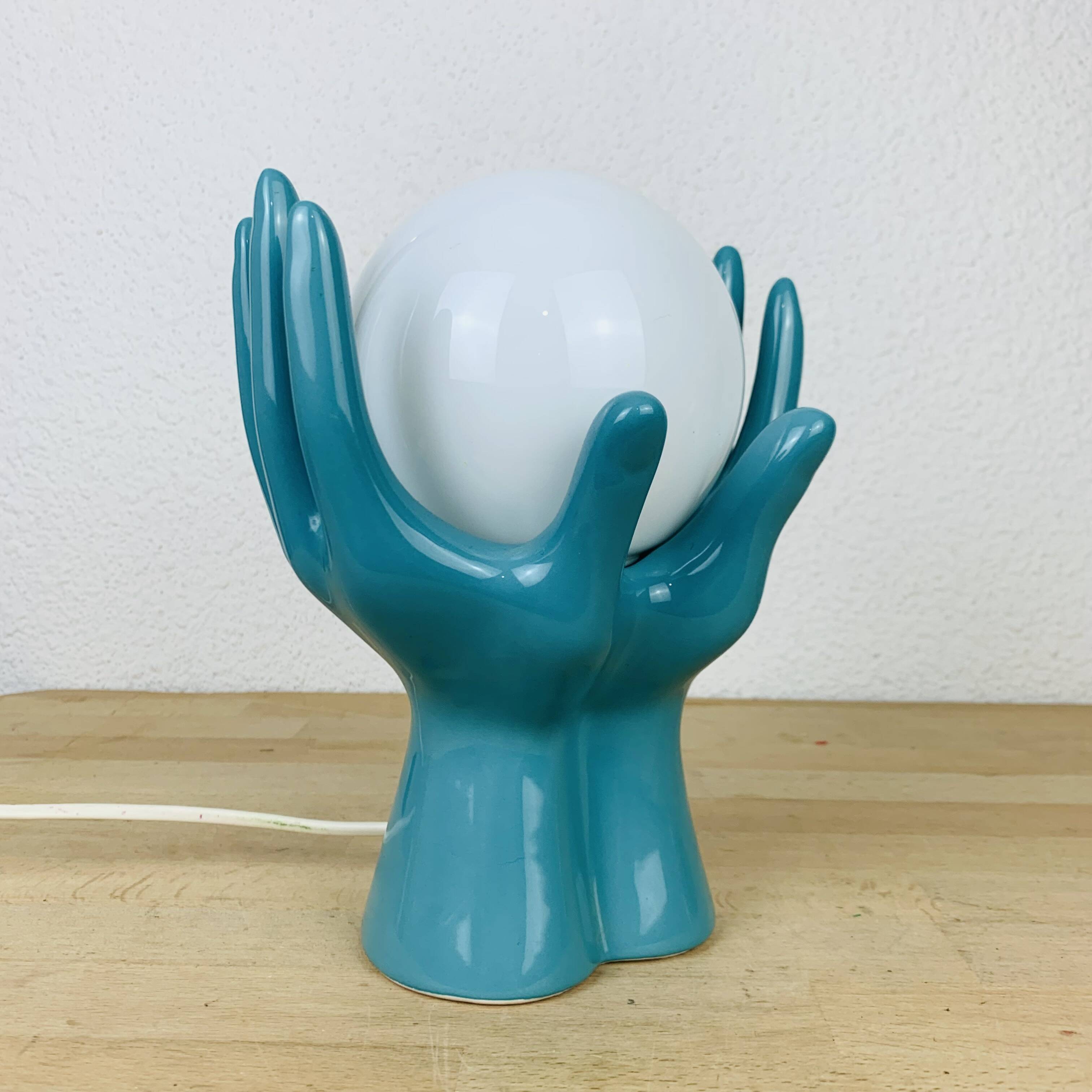 Blue ceramic hands lamp and glass globe