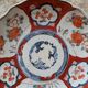 Antique Imari deep plate with red and blue floral decoration, 21.5cm.