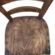 Antique wooden chair with a pyrographed shell motif seat.