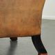 Sheepskin wingback armchair with patina finished with decorative nails