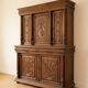 Large antique wooden sideboard carved in rustic style.