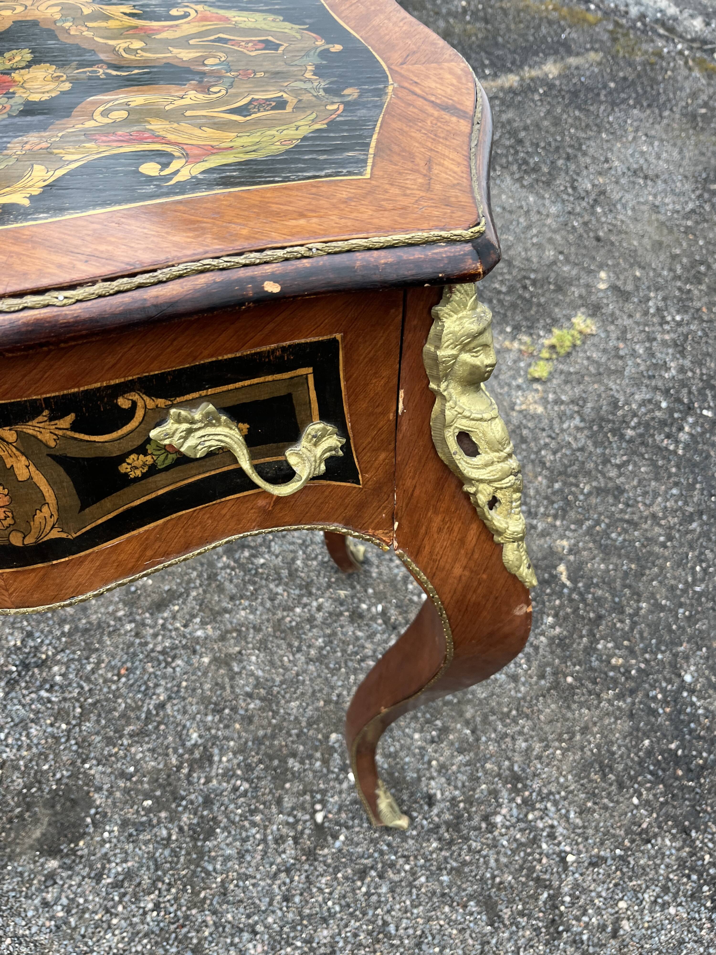 Louis XV style side table with marquetry and gilded bronze.