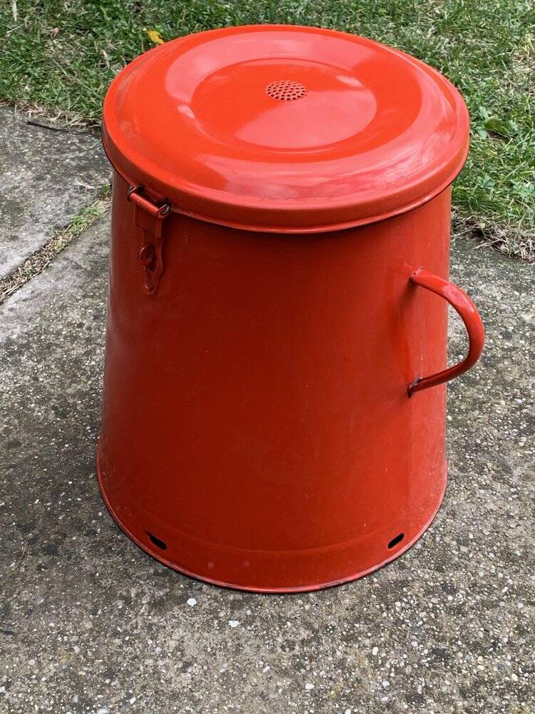 Red enamelled metal bin from the 1950s, with a lockable lid and side handles.