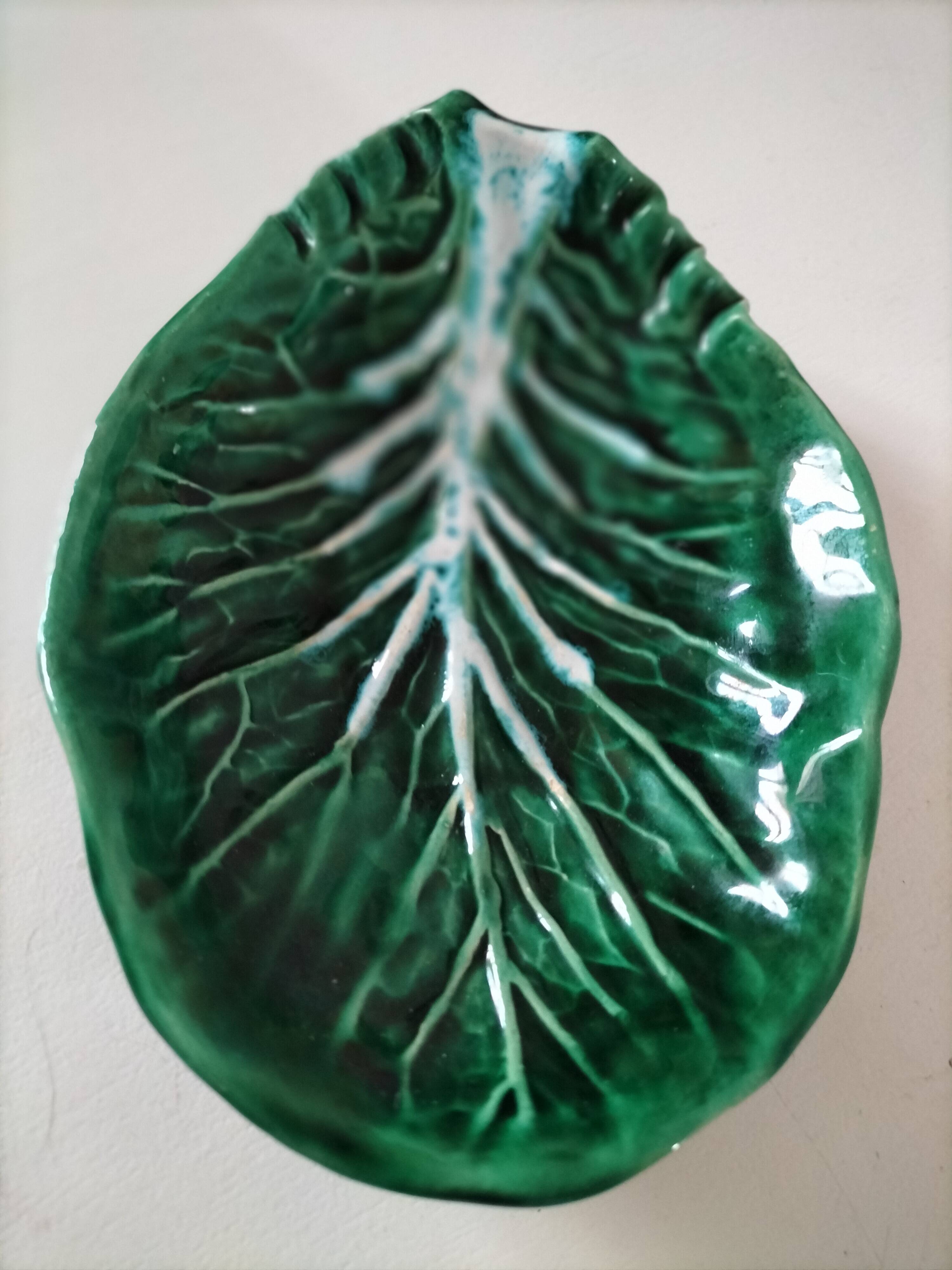 Vintage green slipware bowl in the shape of a cabbage leaf.