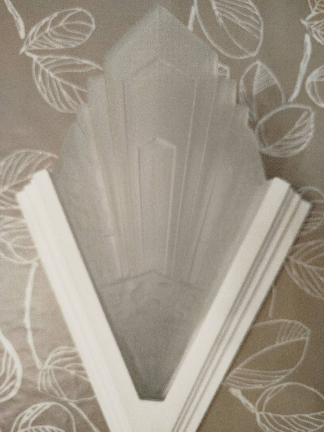 Pair of Art Deco wall sconces in plaster and pressed glass.