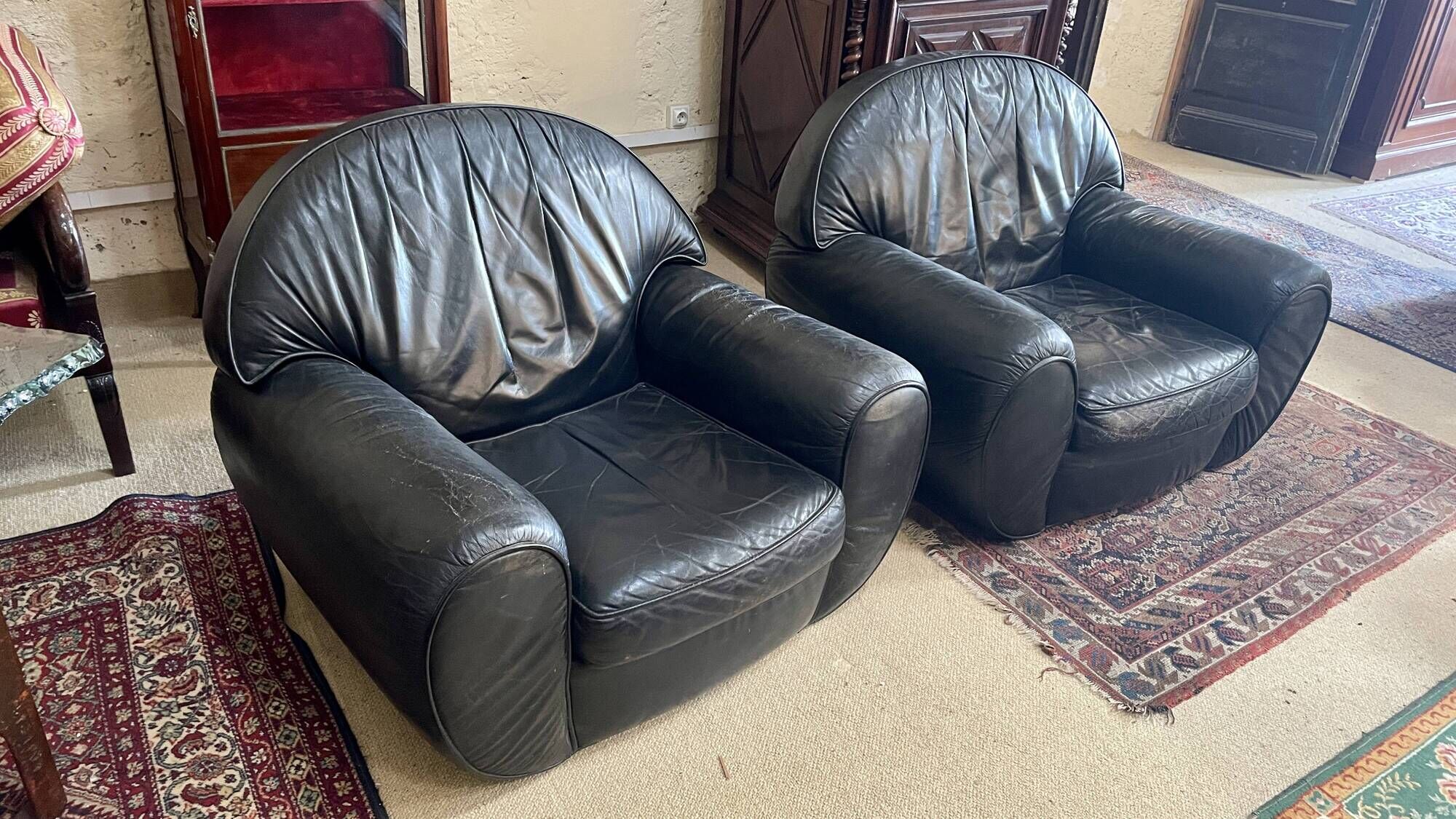 Pair of black leather club armchairs, twentieth century