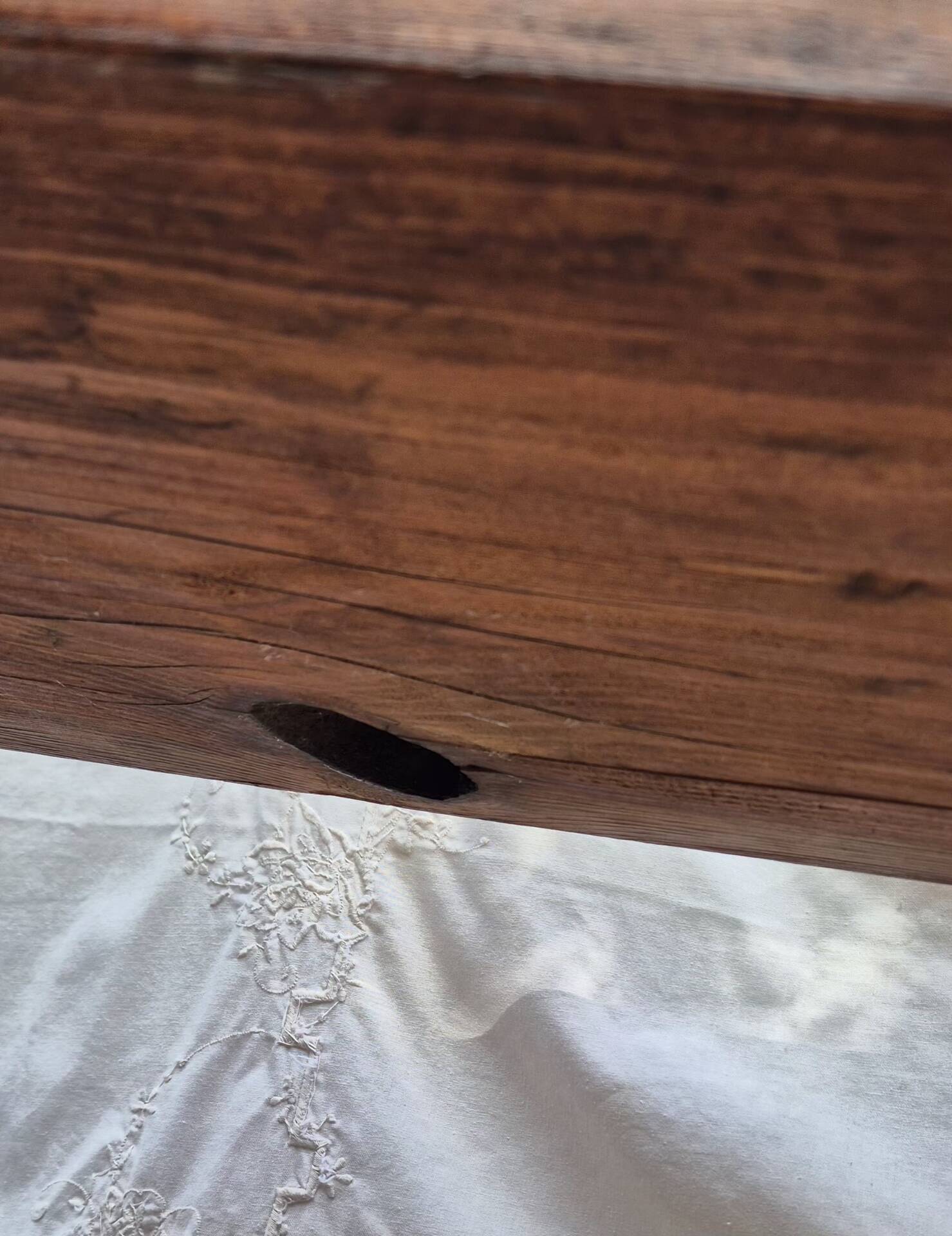 Brutalist wooden bench made of solid oak beam.