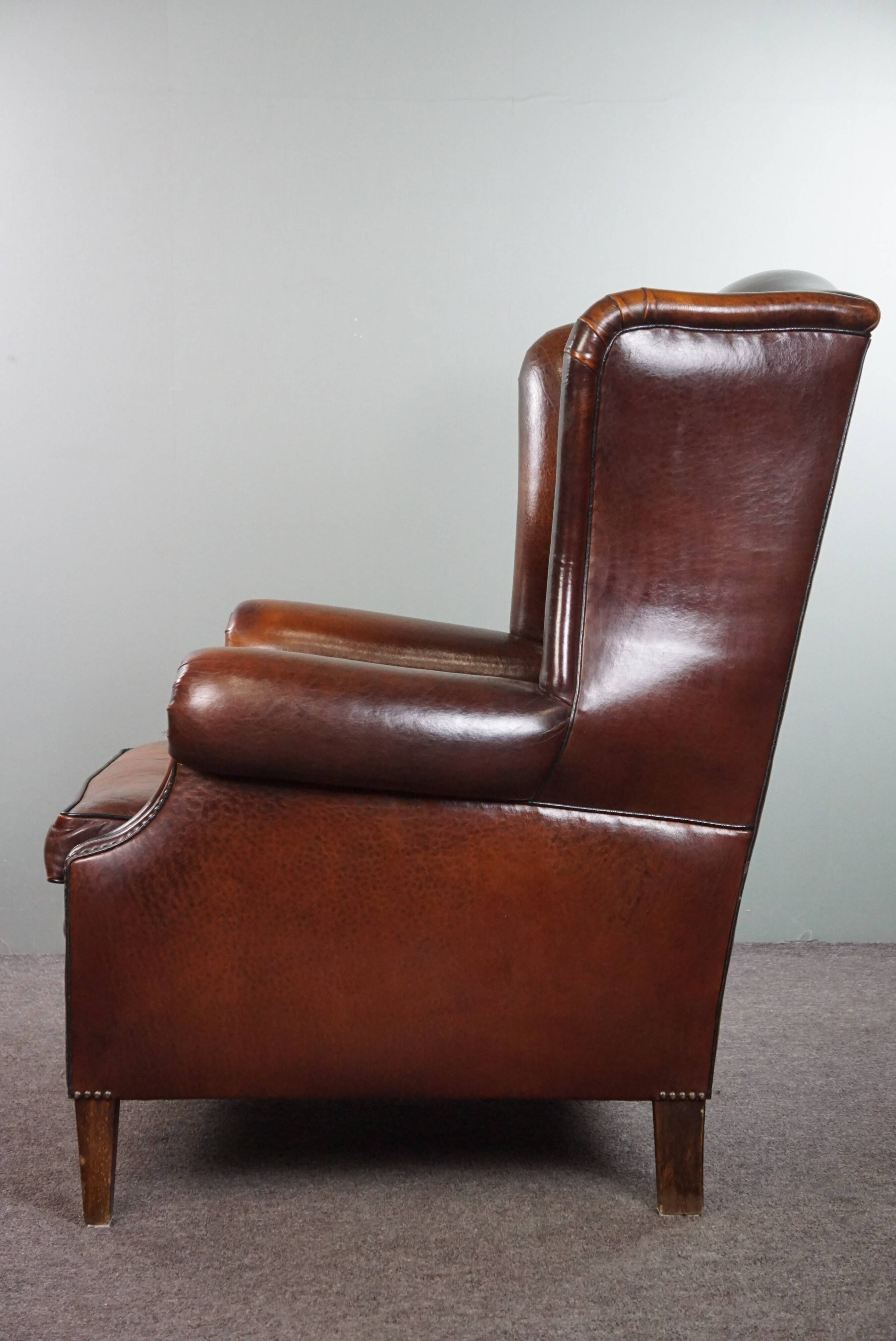 Luxurious large sheep leather wingback armchair with beautiful colors and amazing patina