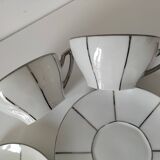 Two Art Deco porcelain cups and saucers with silver trim.