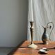 Pair of classic candlesticks in patinated gold metal H25