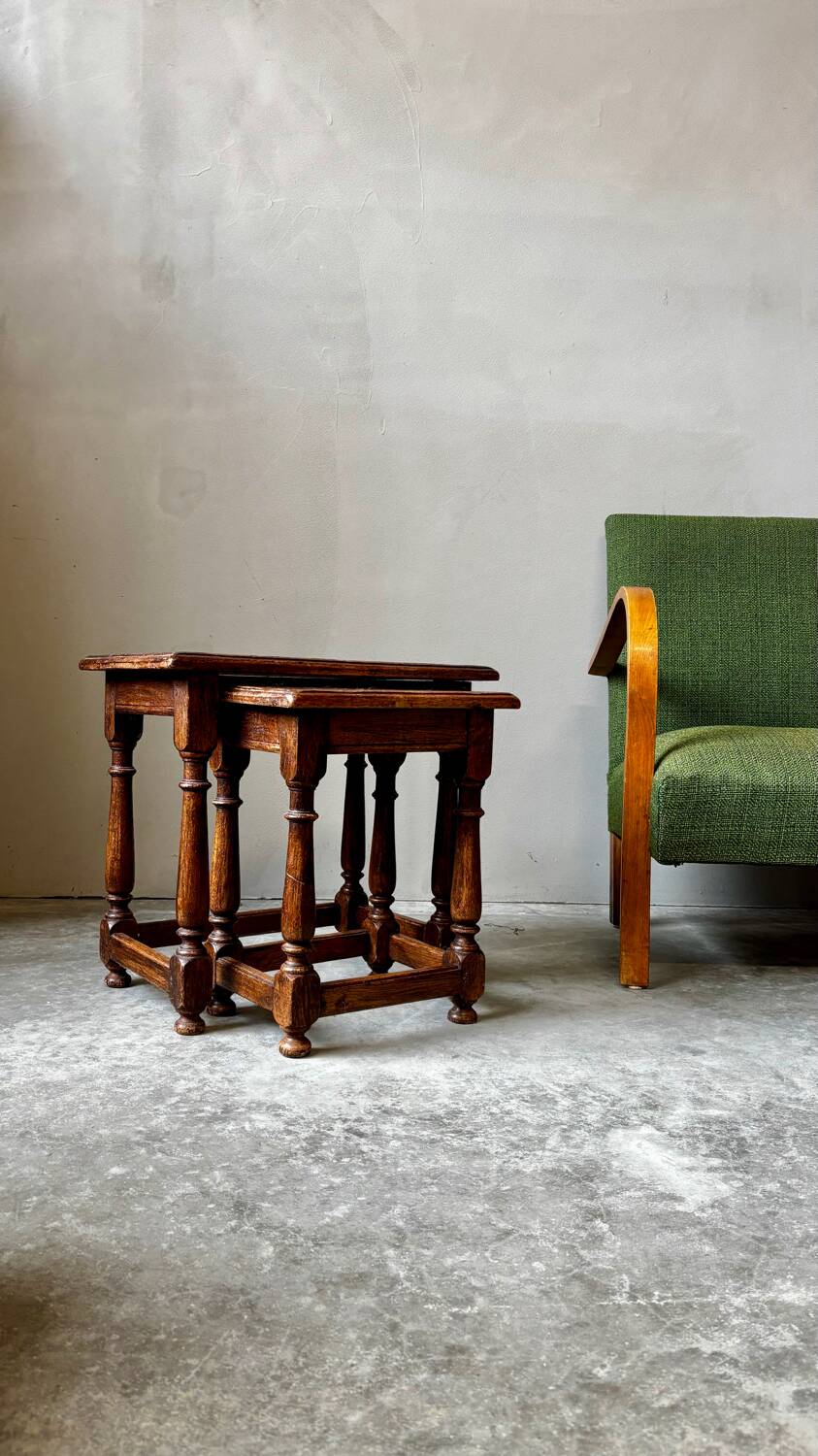 Pair of antique nesting tables made of turned wood.