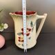 Antique pitcher in slipware with floral decoration – red and cream floral design