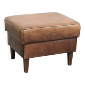 Sheepskin ottoman with a light brown colour scheme and a vintage look
