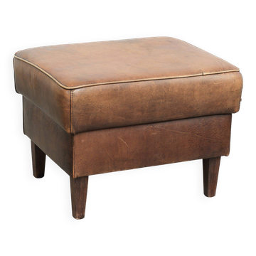 Sheepskin ottoman with a light brown colour scheme and a vintage look