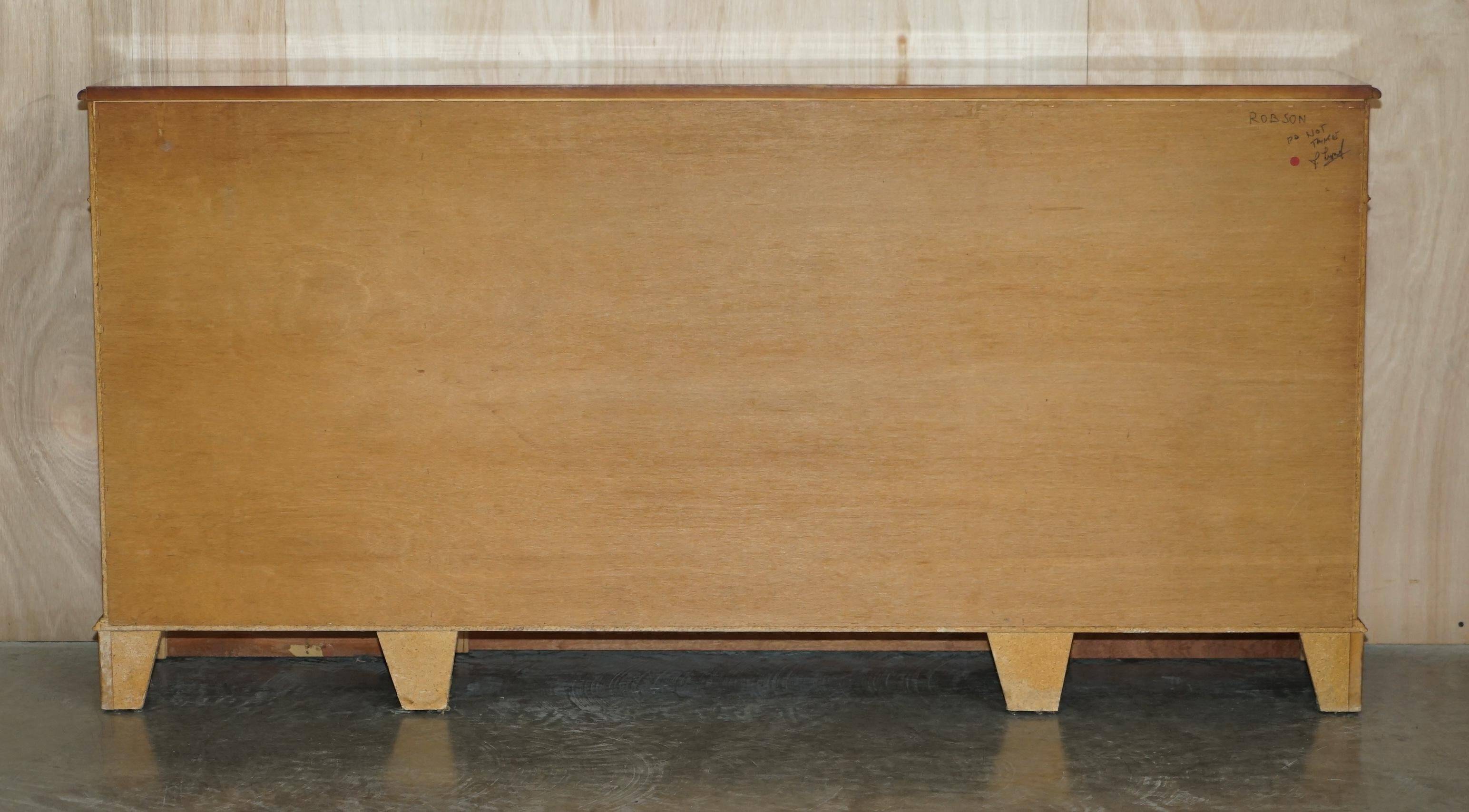 Vintage buffet made of mottled yew wood with three doors and four drawers.