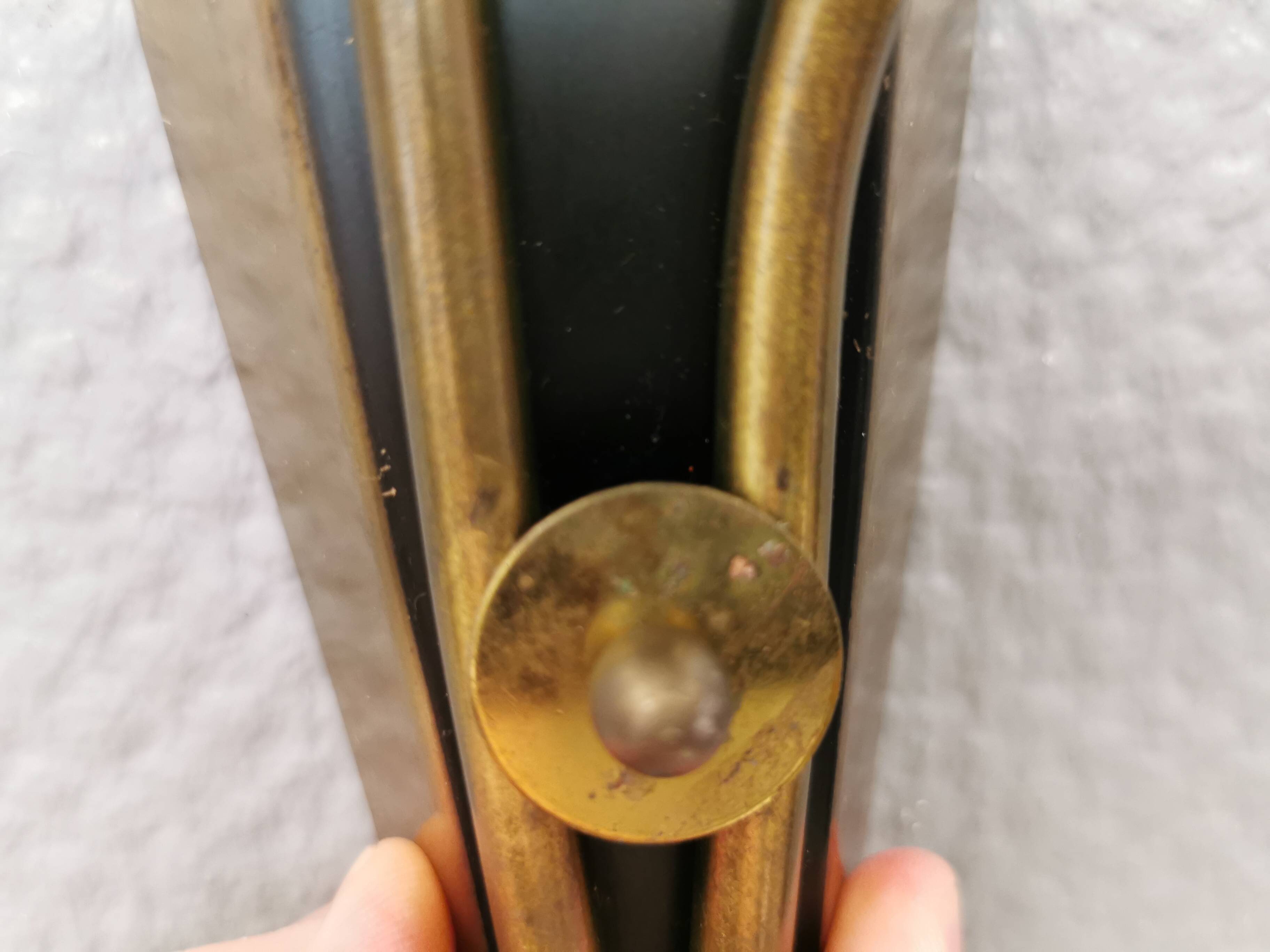 A set of wall lamps in black lacquered metal with brass details