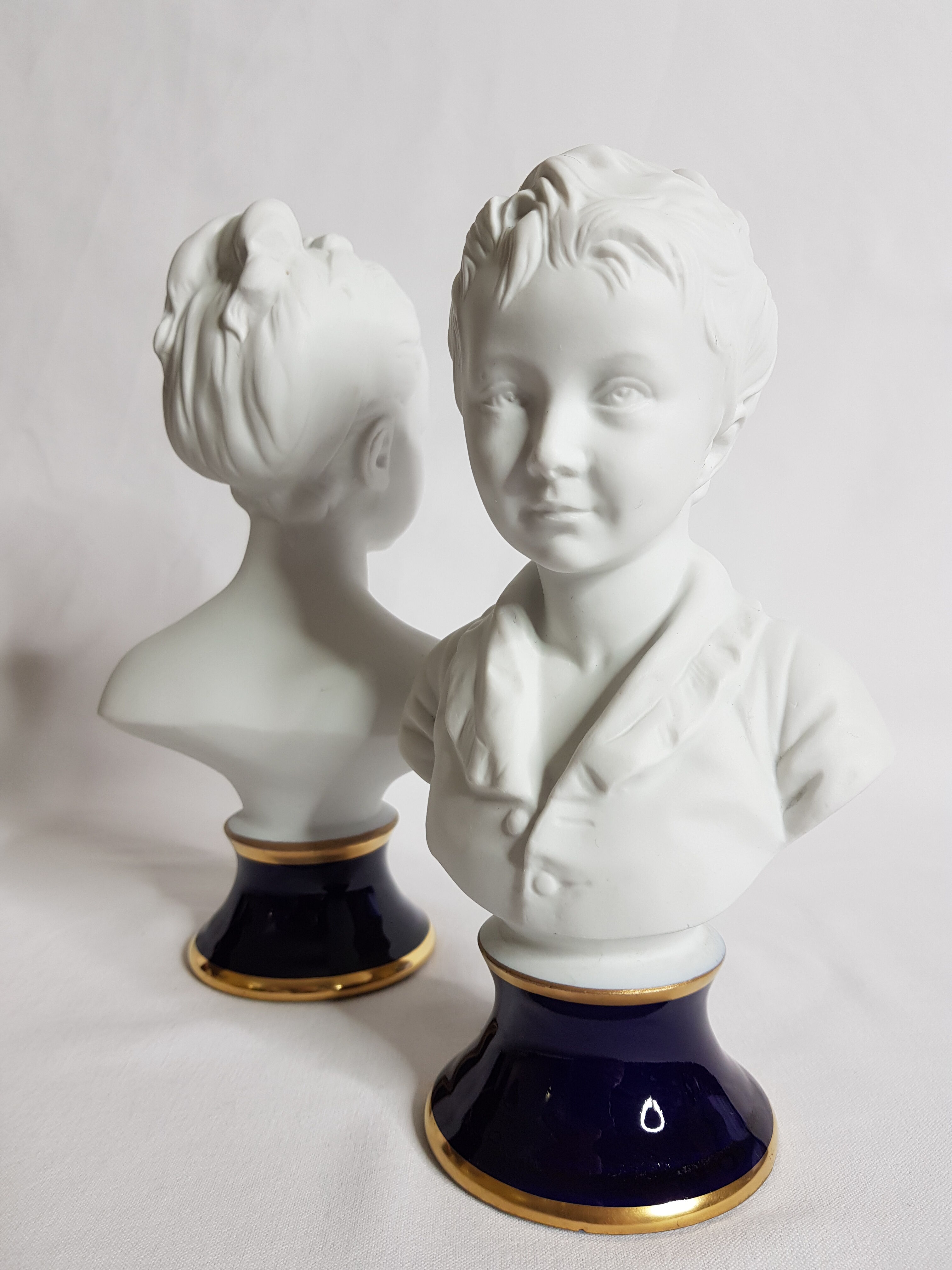 Porcelain biscuit busts by Camille Tharaud, children Louise and Alexandre Brongniart after Houdon