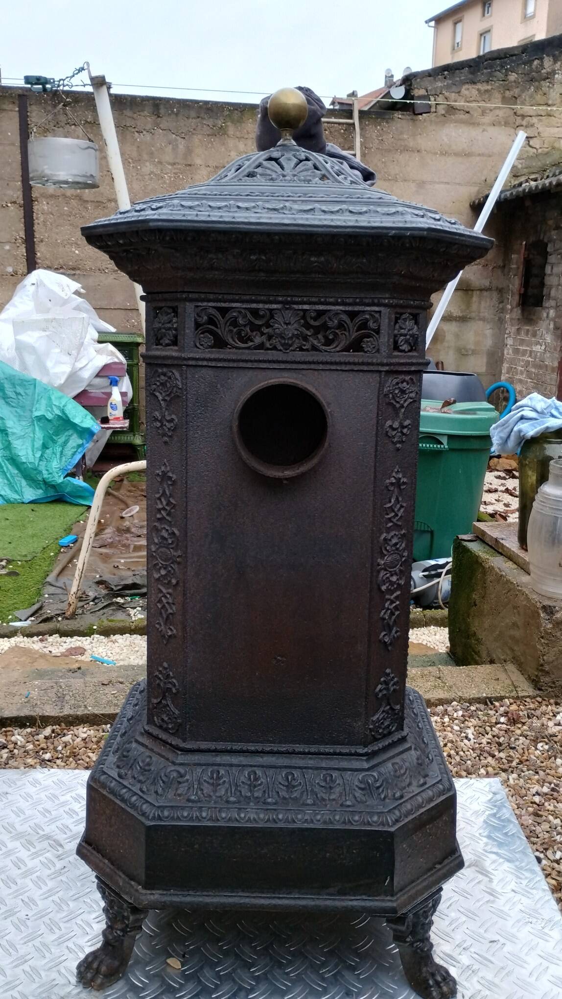 Black cast iron wood burning stove with solid brass handle.