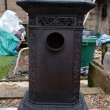 Black cast iron wood burning stove with solid brass handle.