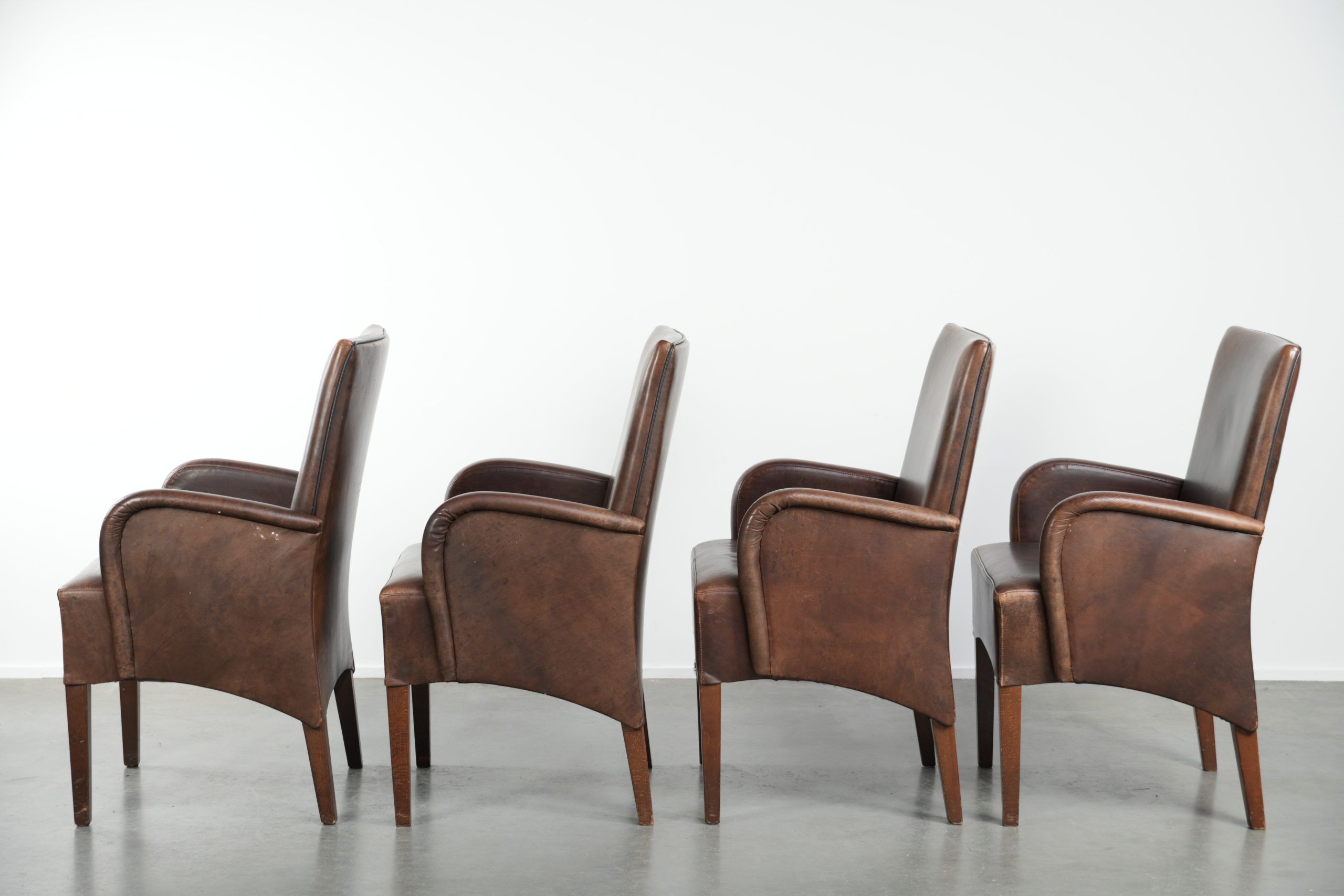 Set of 4 nicely finished dining chairs/side chairs with armrests made of cowhide leather