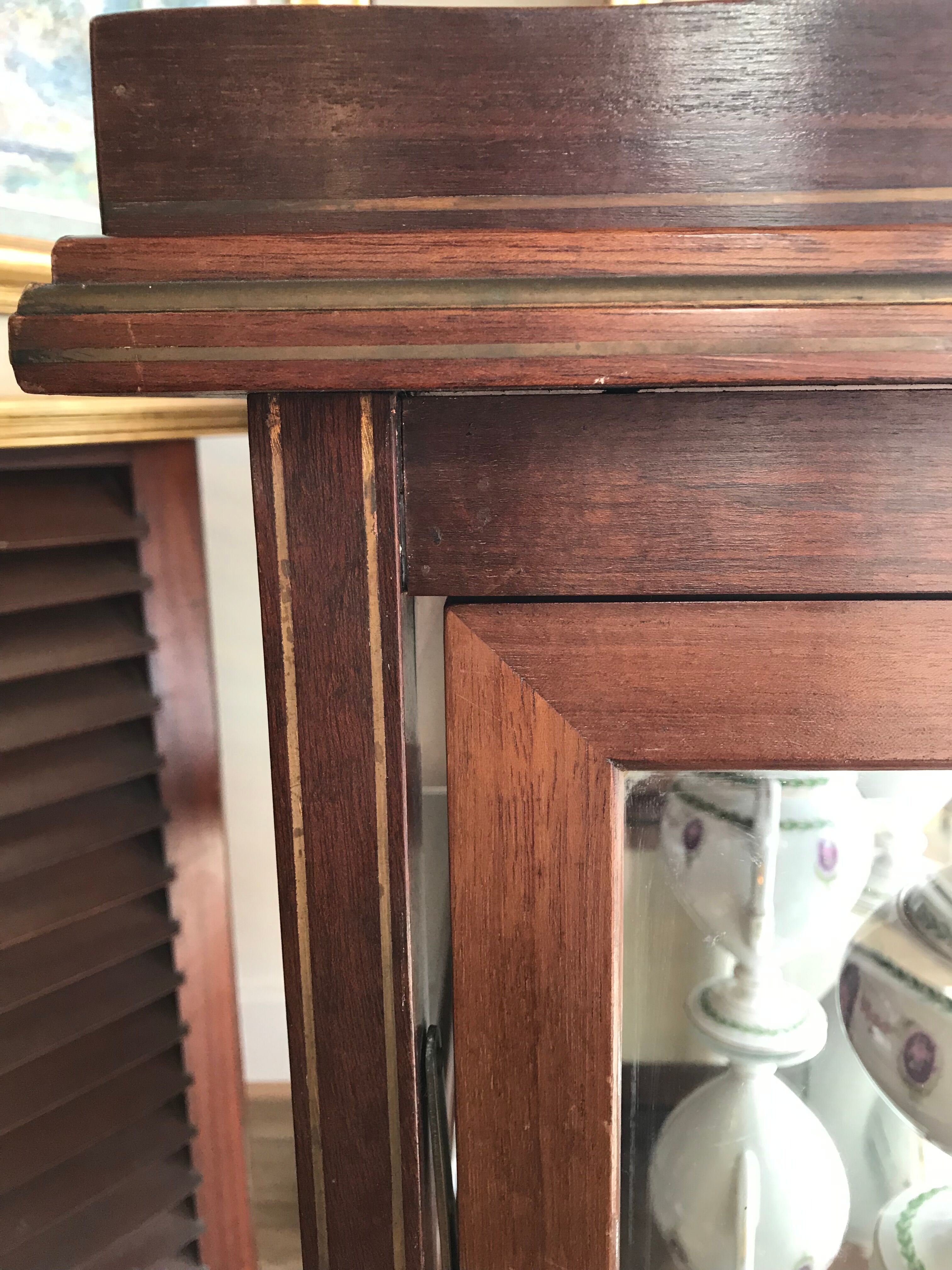 Glass-enclosed old tea table with wooden tray, bronze and brass