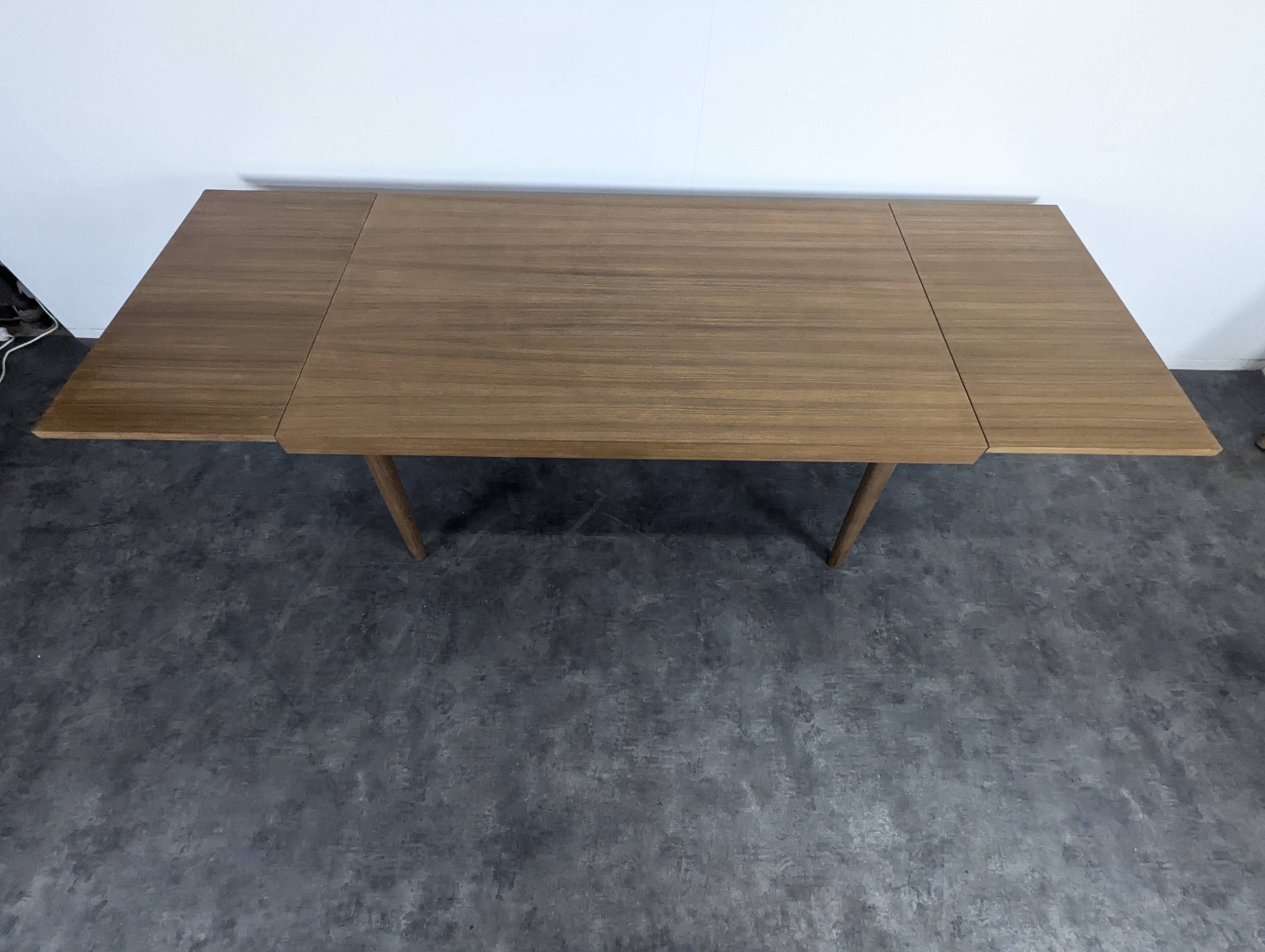 Modernist teak table with 2 extensions.